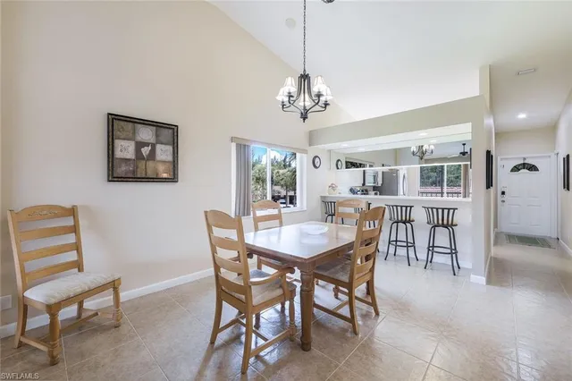a view of a dining room with furniture and a chandelier