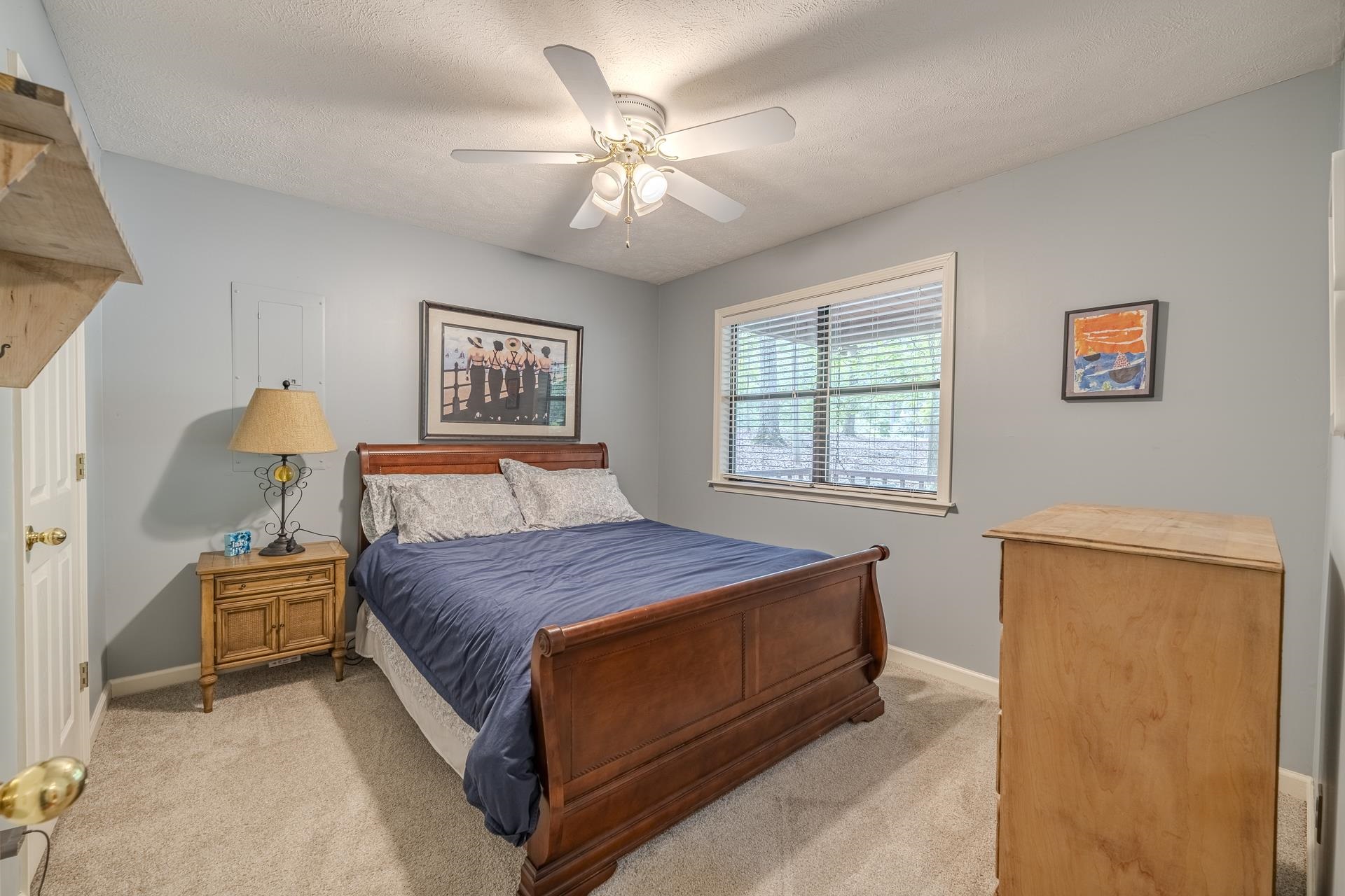 405 Murray Lane Counce, TN 38326 - Photo 22 of 36 a bedroom with a bed and a chandelier