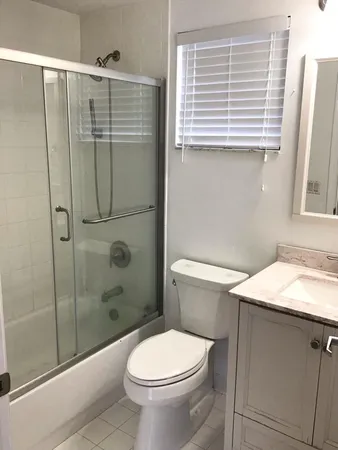 a bathroom with a shower toilet and sink