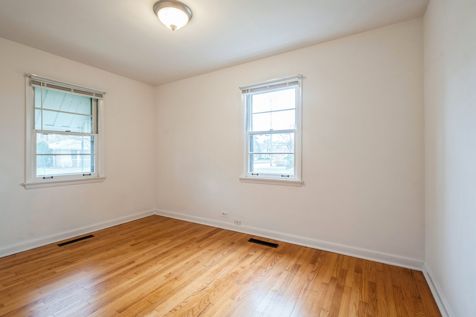 735 Chestnut Street Deerfield, IL 60015 - Photo 14 of 18 an empty room with wooden floor and windows