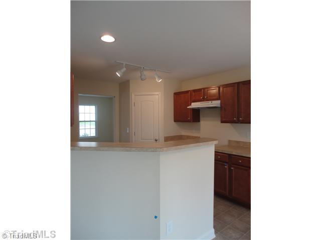 826 Bitting Hall Drive Rural Hall, NC 27045 - Photo 6 of 13 Kitchen. Kitchen features beautiful cabinets and overlooks the den from the sink. Accent lighting provides light where you want it!