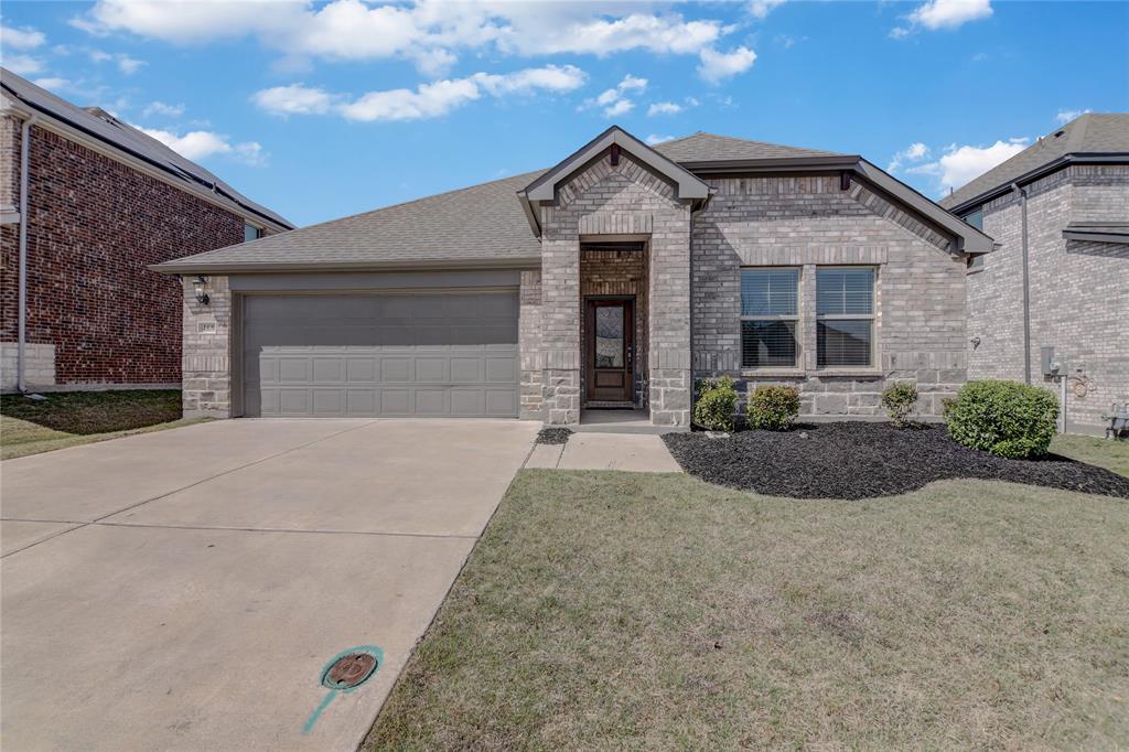 468 Fox Ridge Drive Princeton, TX 75407 - Photo 1 of 1 French provincial home with roof with shingles, a front lawn, brick siding, an attached garage, and concrete driveway