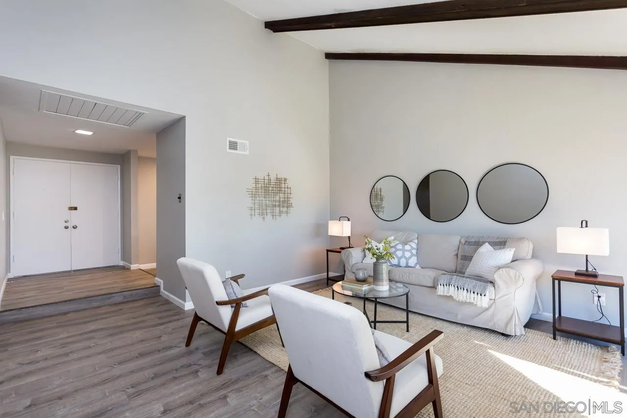 14427 Mirando Street Poway, CA 92064 - Photo 11 of 33 a living room with furniture a mirror and a wooden floor