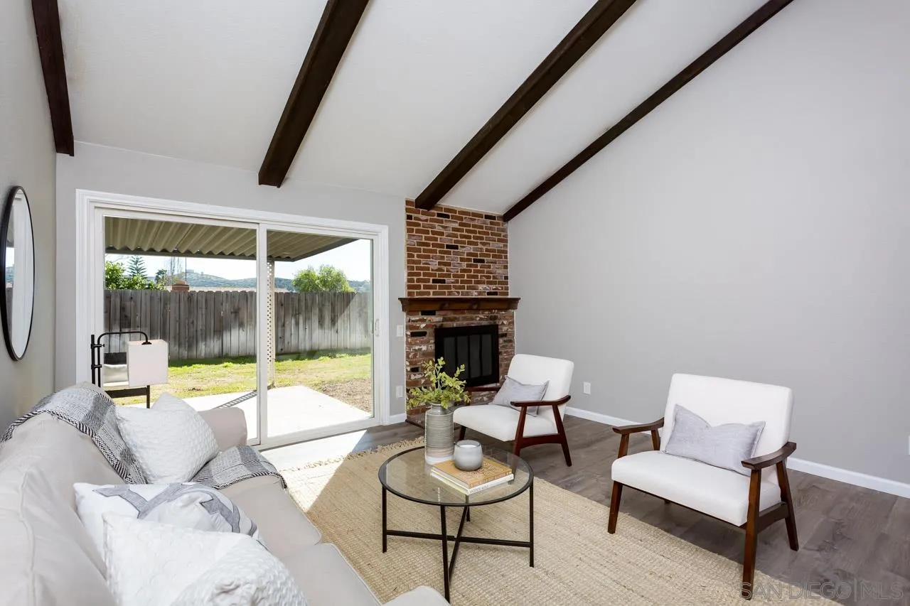 14427 Mirando Street Poway, CA 92064 - Photo 13 of 33 a living room with furniture and a floor to ceiling window