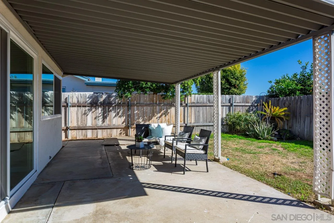 14427 Mirando Street Poway, CA 92064 - Photo 14 of 33 a view of a patio with table and chairs potted plants and floor to ceiling window