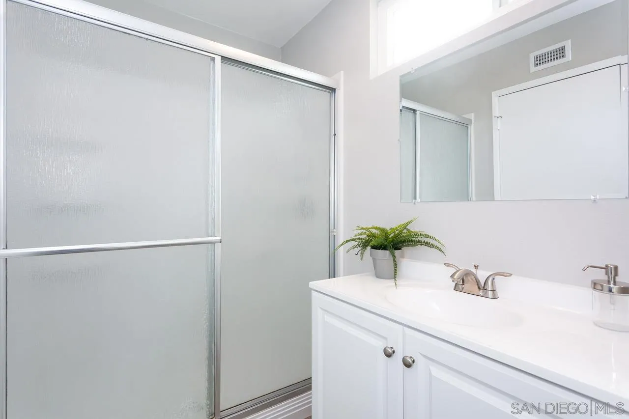 14427 Mirando Street Poway, CA 92064 - Photo 20 of 33 a bathroom with a sink and a mirror