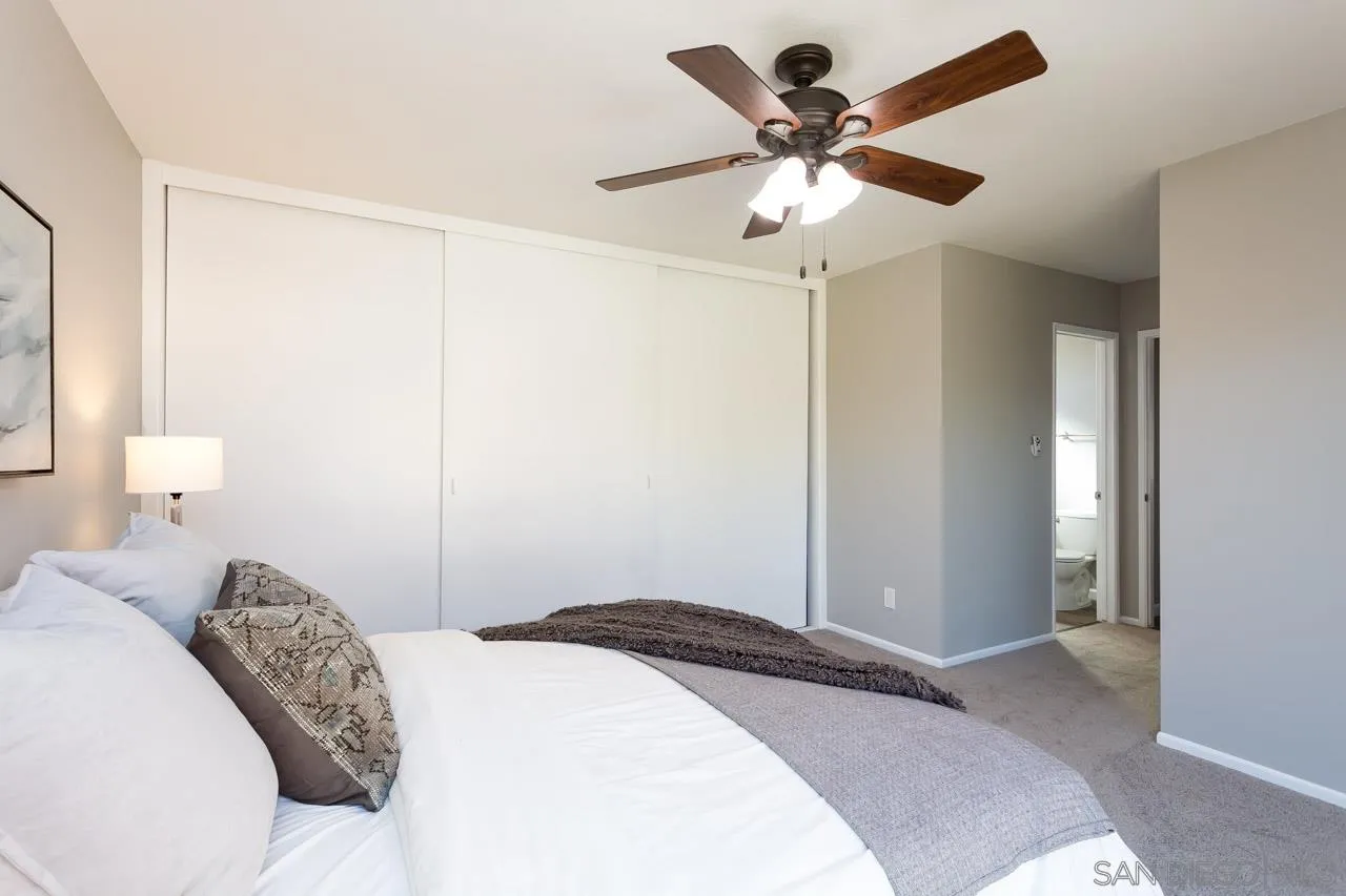 14427 Mirando Street Poway, CA 92064 - Photo 21 of 33 a bedroom with a large bed and a ceiling fan