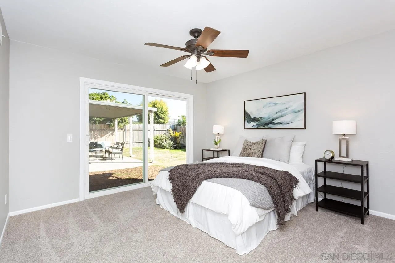 14427 Mirando Street Poway, CA 92064 - Photo 22 of 33 a spacious bedroom with a bed and a large window