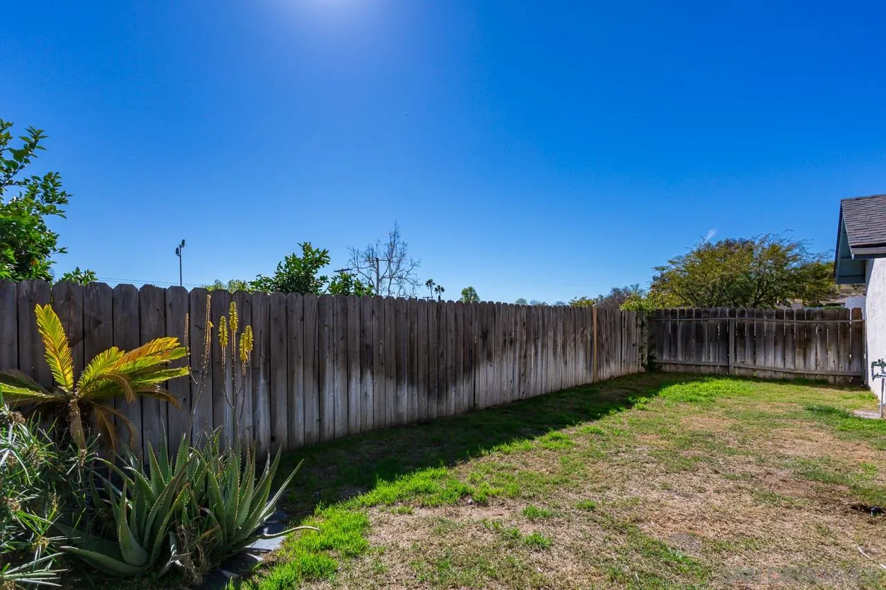 14427 Mirando Street Poway, CA 92064 - Photo 29 of 33 a view of a backyard with wooden fence