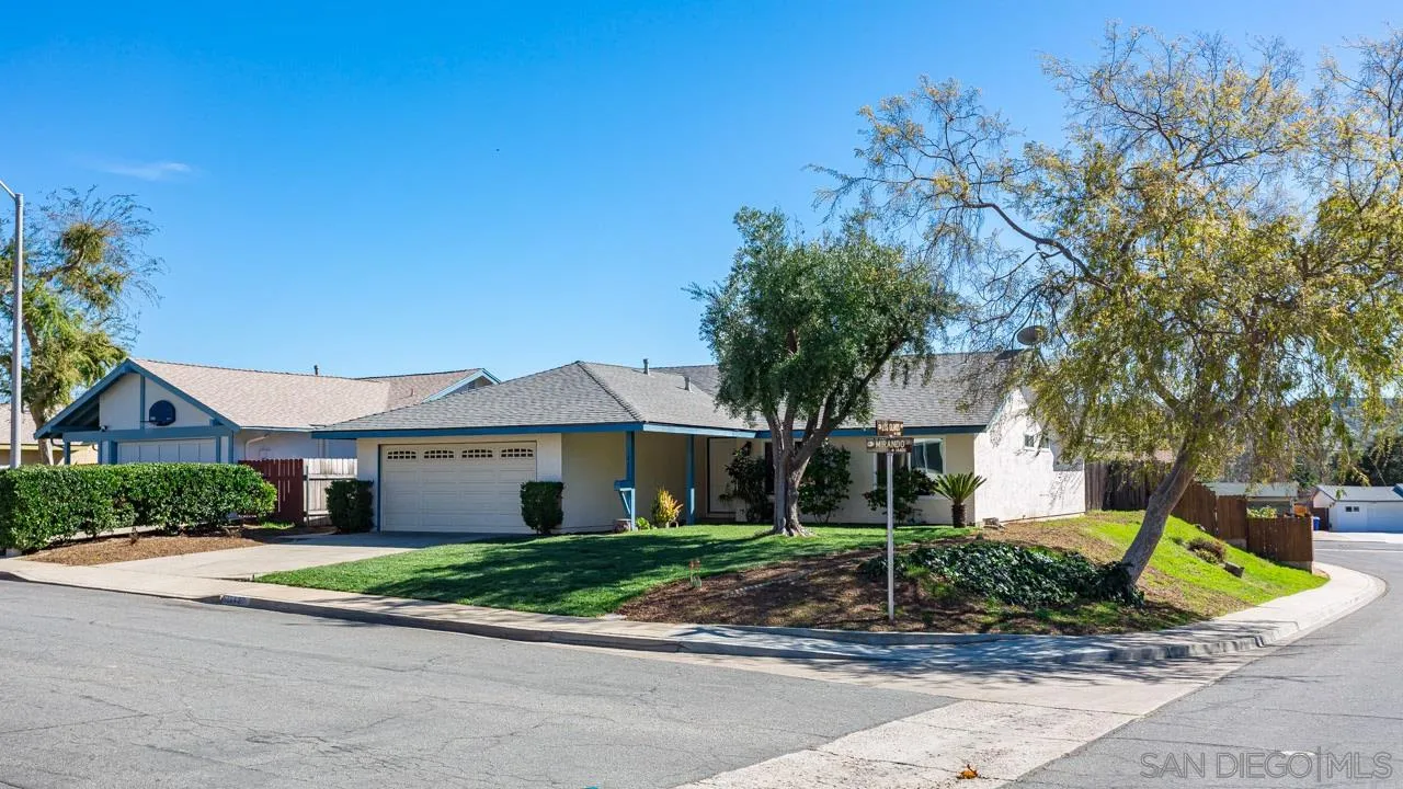14427 Mirando Street Poway, CA 92064 - Photo 32 of 33 a front view of a house with a garden and trees