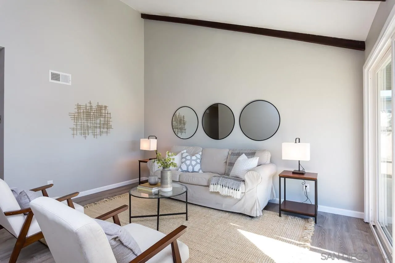 14427 Mirando Street Poway, CA 92064 - Photo 10 of 33 a living room with furniture a mirror and a wooden floor