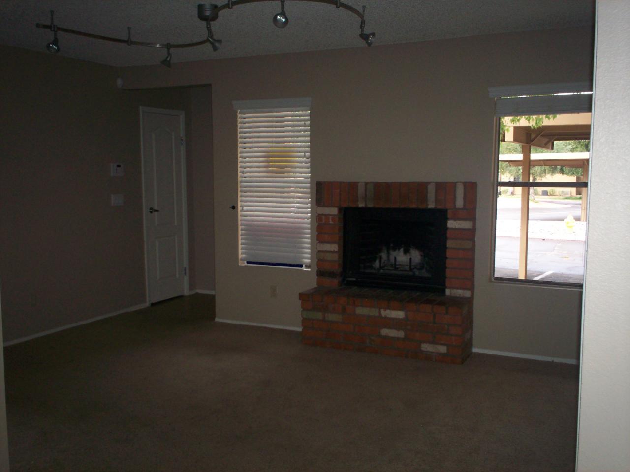 3511 East Baseline Road, Unit 1166 Phoenix, AZ 85042 - Photo 2 of 5 a living room with a fireplace
