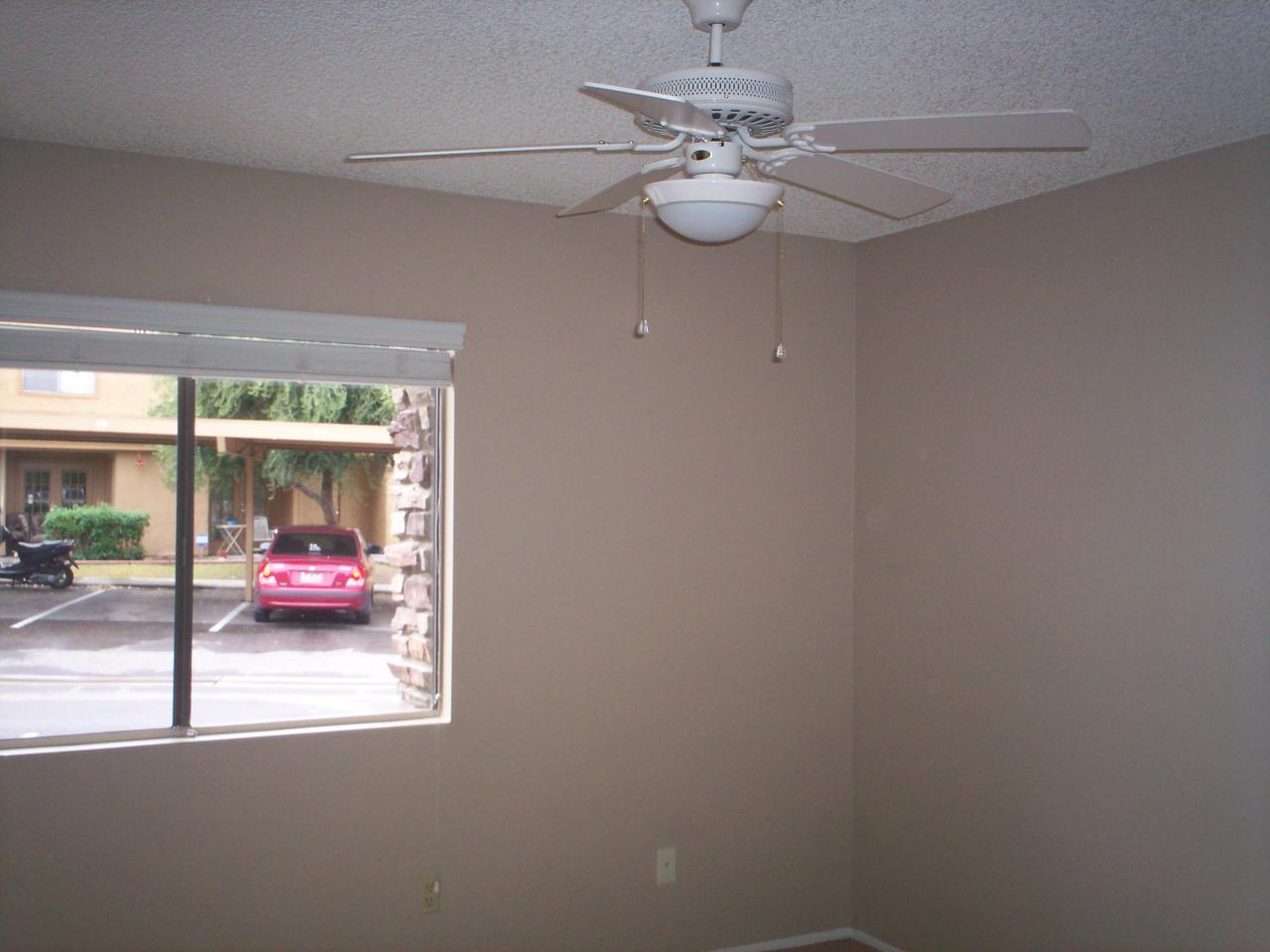 3511 East Baseline Road, Unit 1166 Phoenix, AZ 85042 - Photo 5 of 5 a view of a dining room with furniture a chandelier fan and window