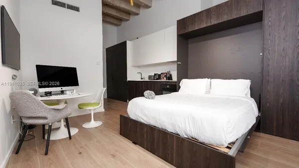 a kitchen with a cabinets and wooden floor