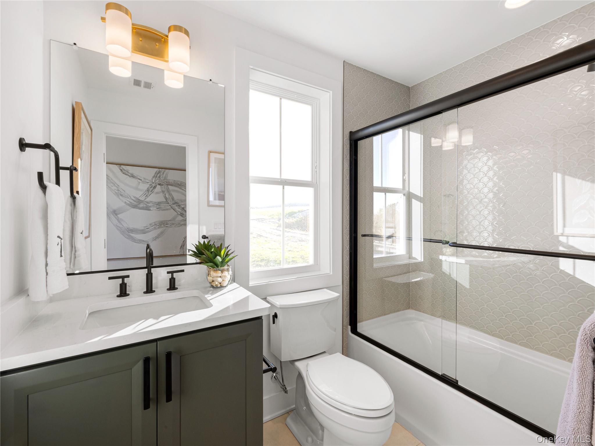 5110 Teaberry Lane, Unit 31 Fishkill, NY 12524 - Photo 5 of 10 Full bath with enclosed tub / shower combo, vanity, and a chandelier