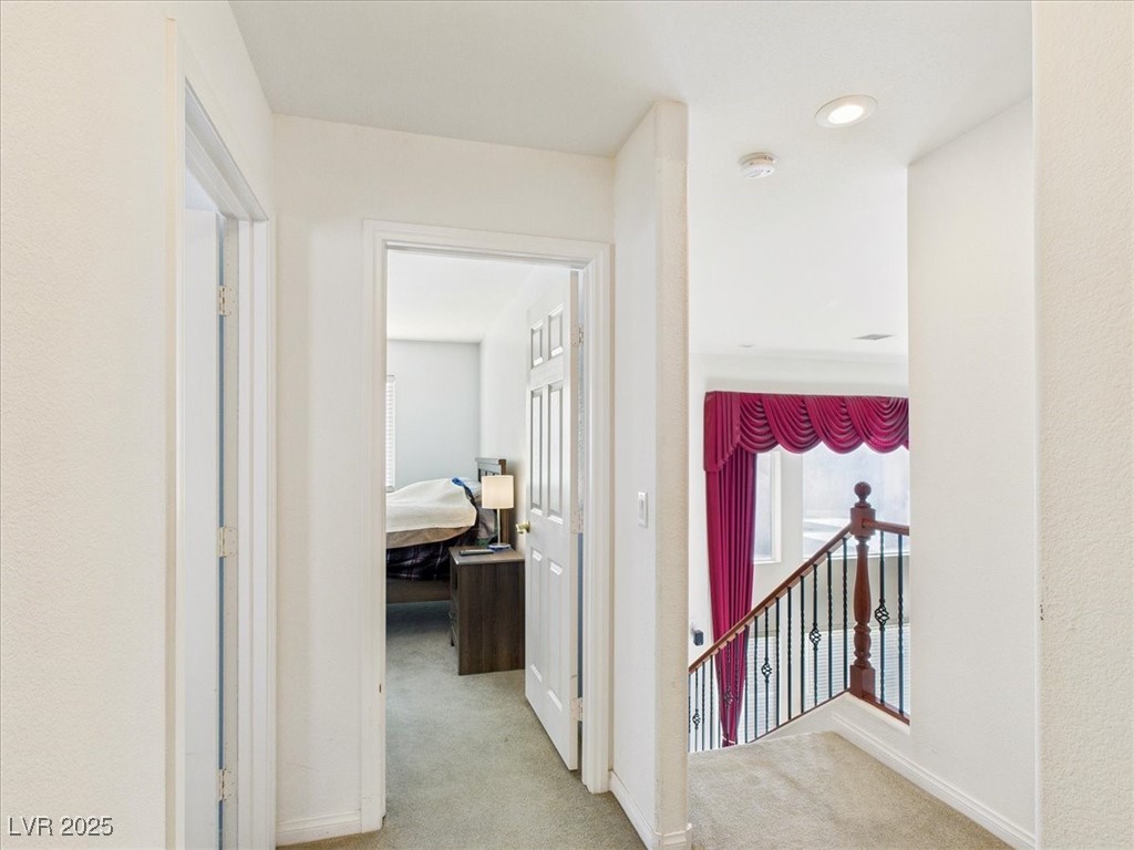 321 Whispering Tree Avenue Las Vegas, NV 89183 - Photo 60 of 95 Hall with light carpet and an upstairs landing