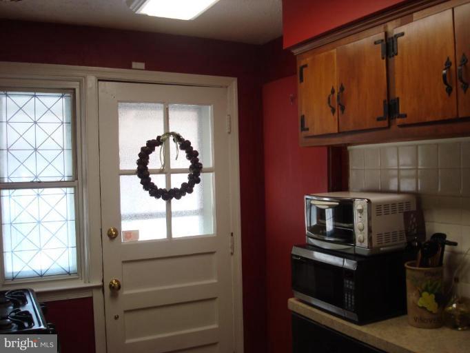 1009 Downton Road Halethorpe, MD 21227 - Photo 11 of 30 a kitchen with a stove and a window