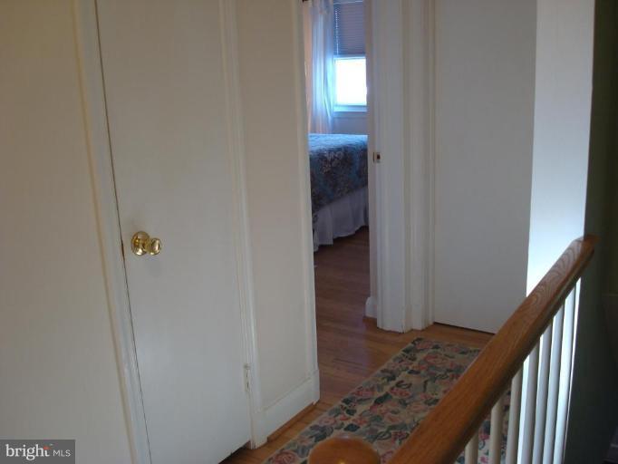 1009 Downton Road Halethorpe, MD 21227 - Photo 20 of 30 a view of hallway with wooden floor and stairs