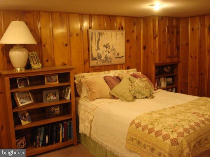1009 Downton Road Halethorpe, MD 21227 - Photo 24 of 30 a bedroom with a bed and a book shelf