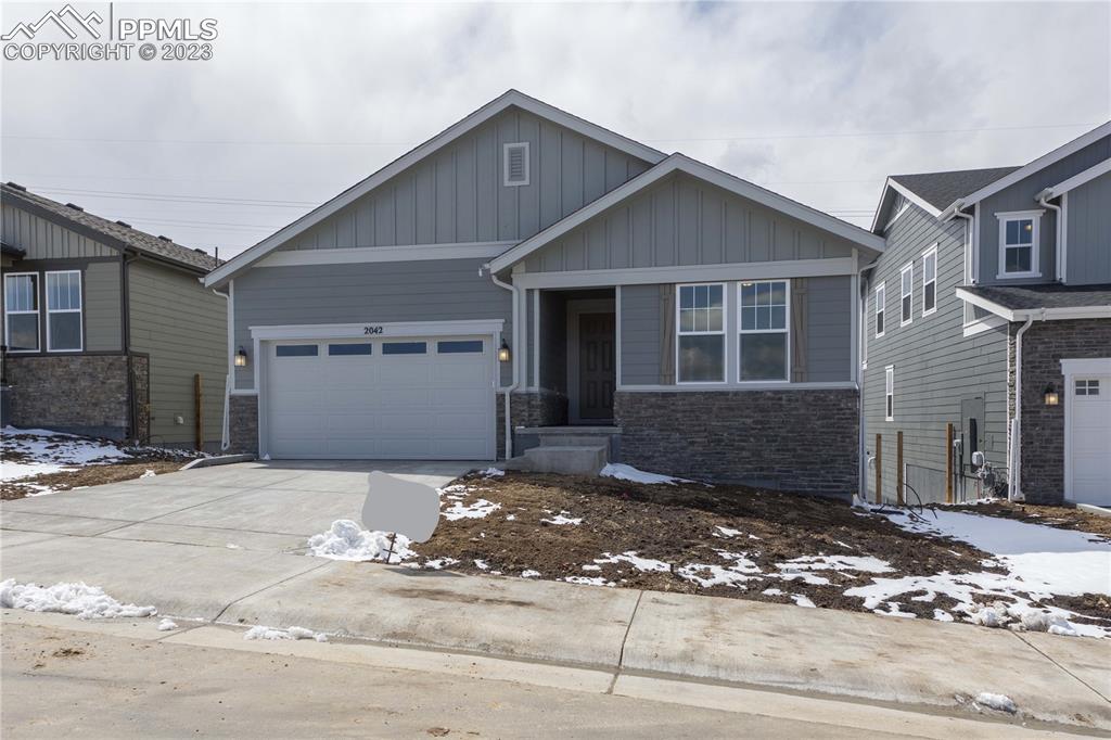 2042 Peachleaf Loop Castle Rock, CO 80108 - Photo 2 of 26 a front view of a house with a yard