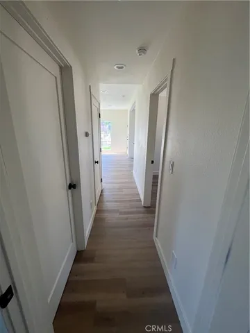 a view of a hallway with wooden floor