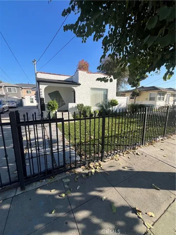 a view of a house with a wooden fence