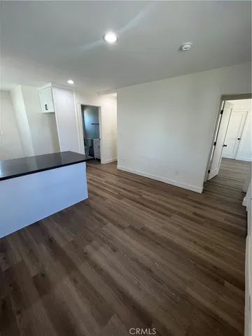 a view of a room with wooden floor