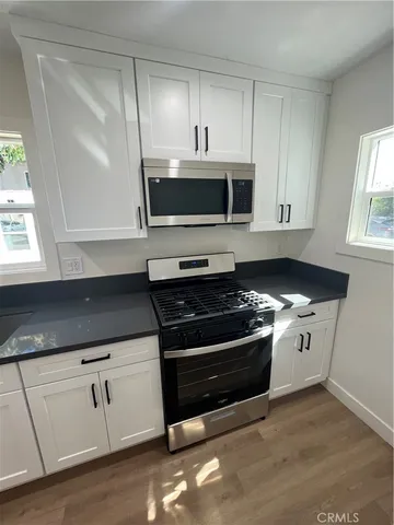 a view of kitchen with wooden floor