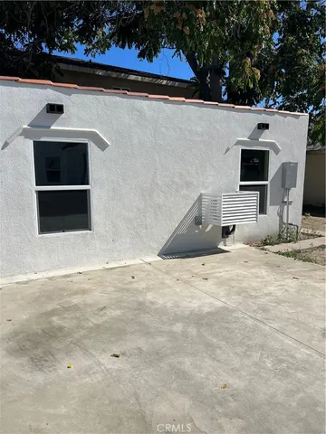 a view of a hallway with wooden floor and entryway