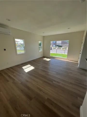 a view of kitchen and empty room with kitchen island