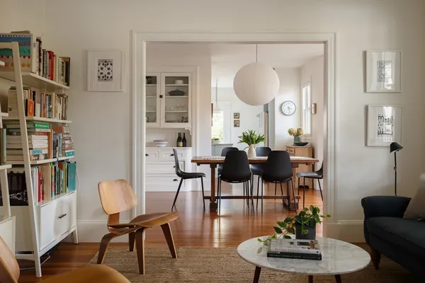 a view of a dining room with furniture and a book shelf