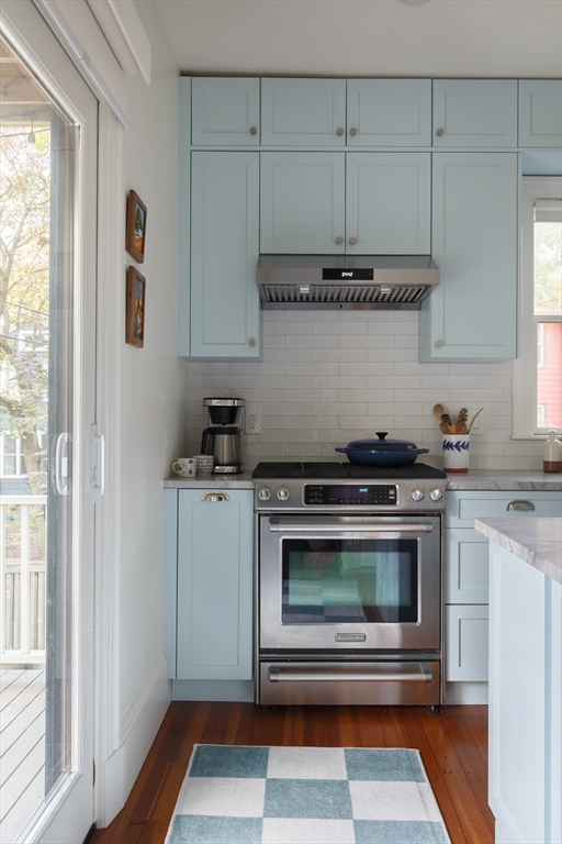 465 Huron Avenue, Unit 1 Cambridge, MA 02138 - Photo 11 of 23 a kitchen with stainless steel appliances granite countertop a stove a microwave and a white cabinets