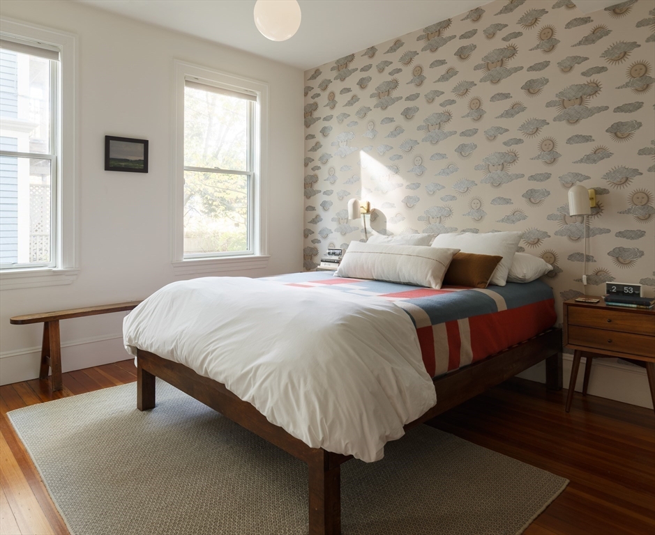 465 Huron Avenue, Unit 1 Cambridge, MA 02138 - Photo 12 of 23 a bedroom with a bed lamps and window