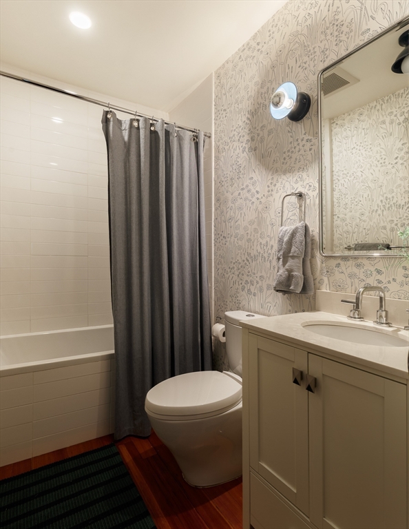 465 Huron Avenue, Unit 1 Cambridge, MA 02138 - Photo 17 of 23 a bathroom with a sink a toilet a mirror and shower