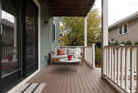 a balcony with wooden floor and furniture