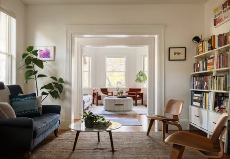 a living room with furniture and a potted plant