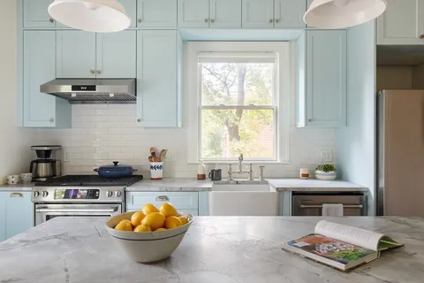 a kitchen with stainless steel appliances a sink a counter and a window