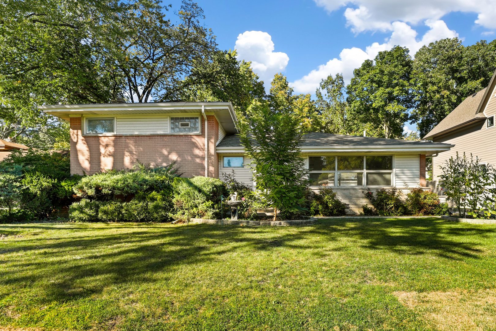 a front view of house with yard and green space