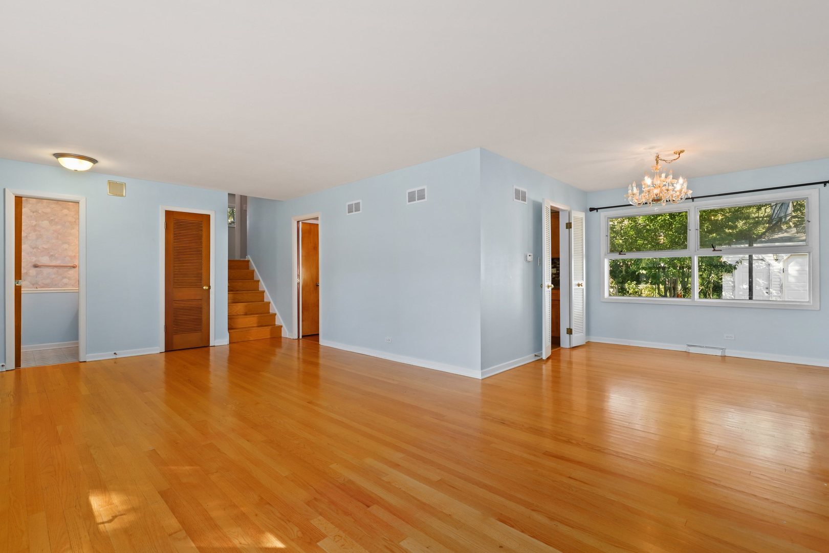 410 Ferndale Road Glenview, IL 60025 - Photo 4 of 34 a view of an empty room with a window and wooden floor