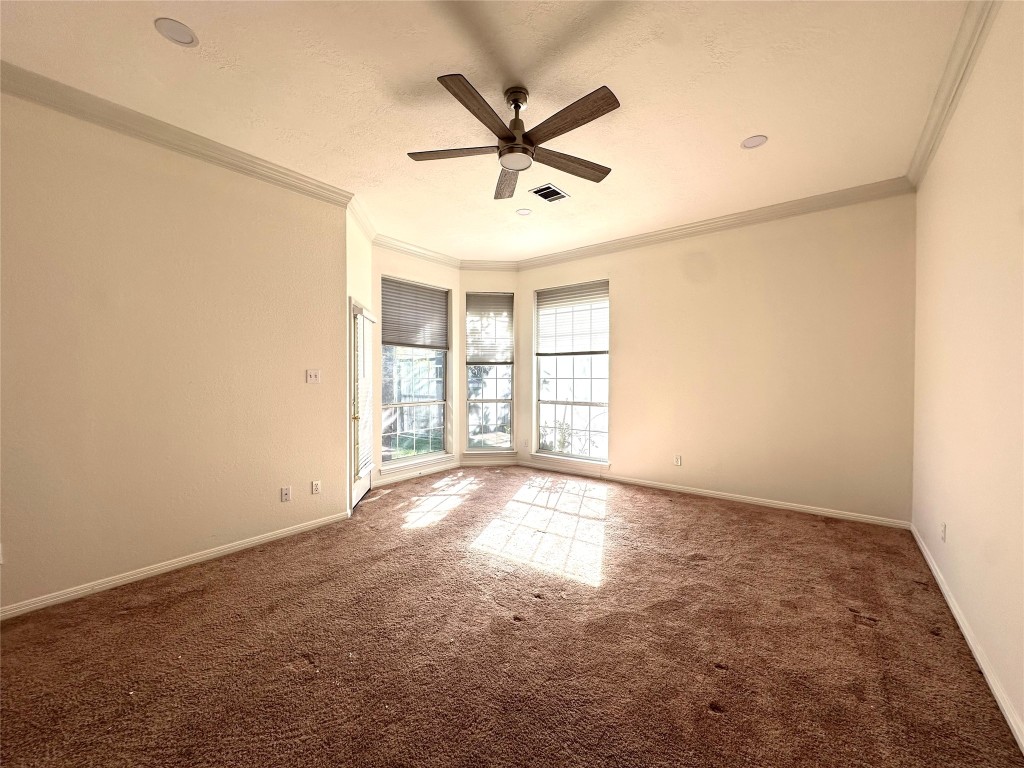 10305 Open Gate Drive Austin, TX 78726 - Photo 16 of 25 an empty room with windows and fan