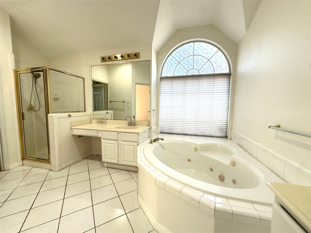 10305 Open Gate Drive Austin, TX 78726 - Photo 17 of 25 a bathroom with a tub a sink and a mirror