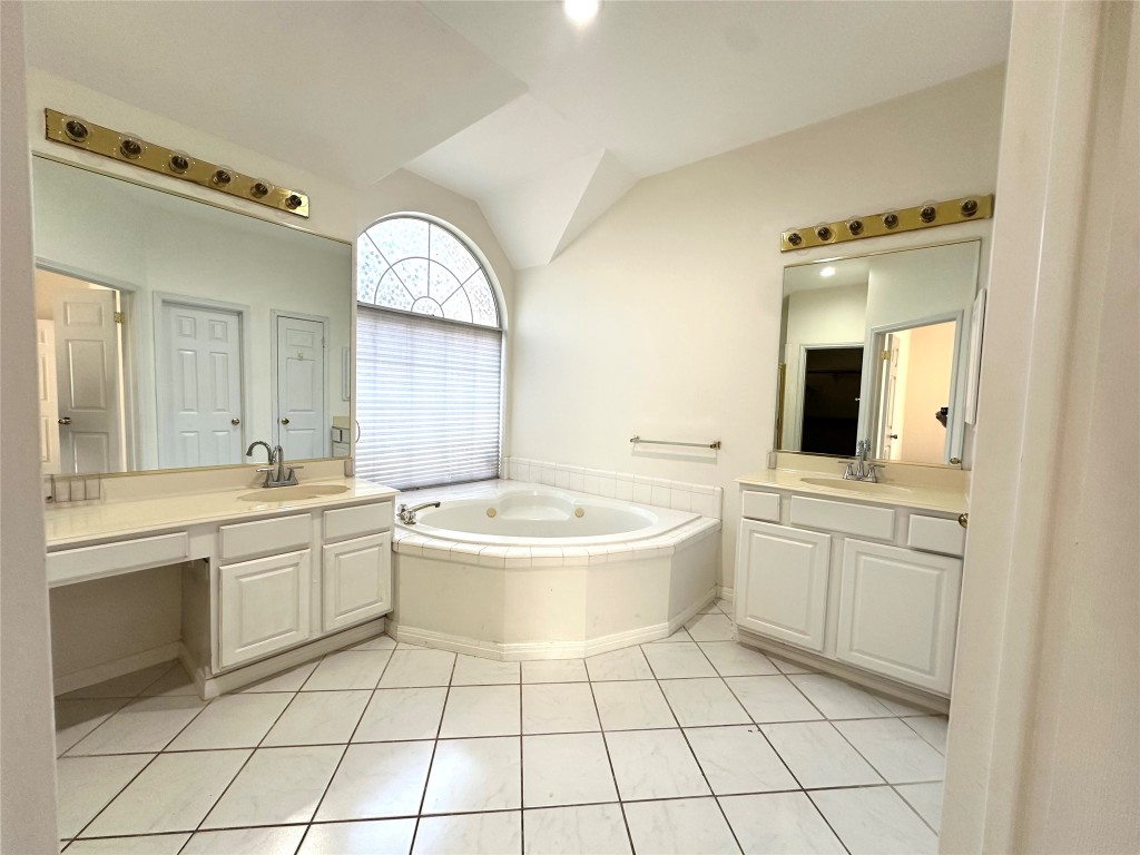 10305 Open Gate Drive Austin, TX 78726 - Photo 18 of 25 a bathroom with a sink a toilet and mirror