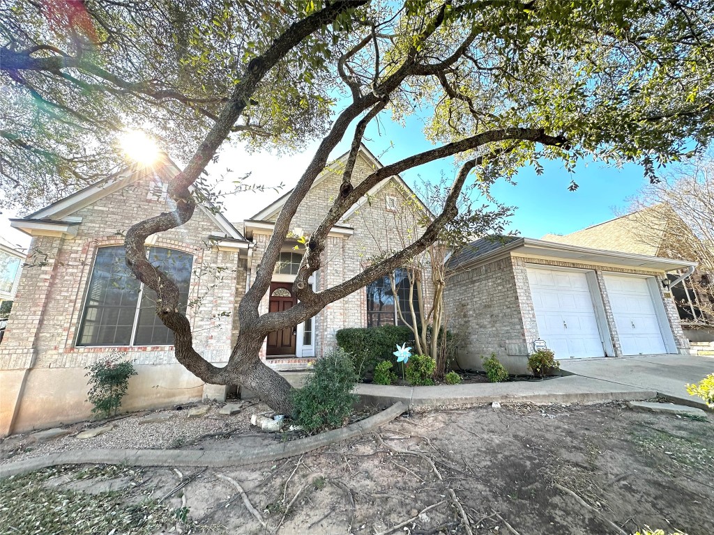 10305 Open Gate Drive Austin, TX 78726 - Photo 2 of 25 a view of a garage with a tree