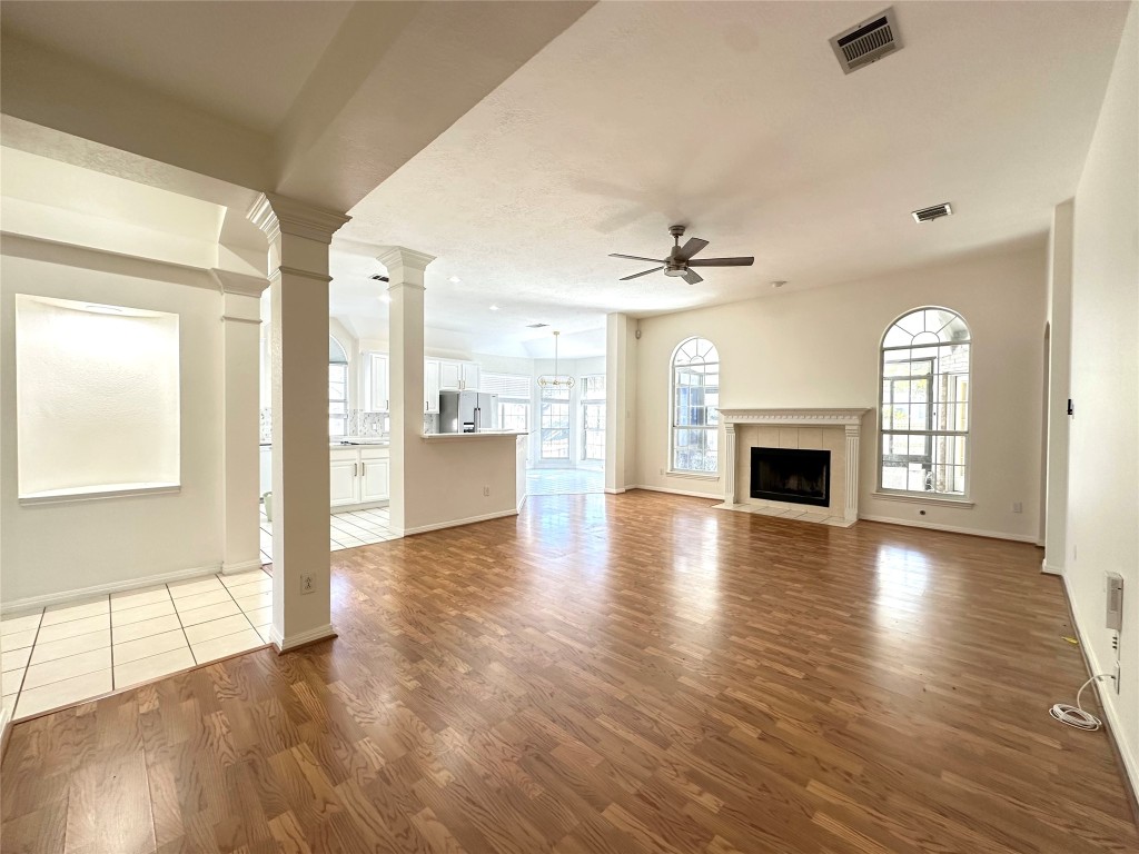 10305 Open Gate Drive Austin, TX 78726 - Photo 9 of 25 a view of a livingroom with a fireplace wooden floor and windows