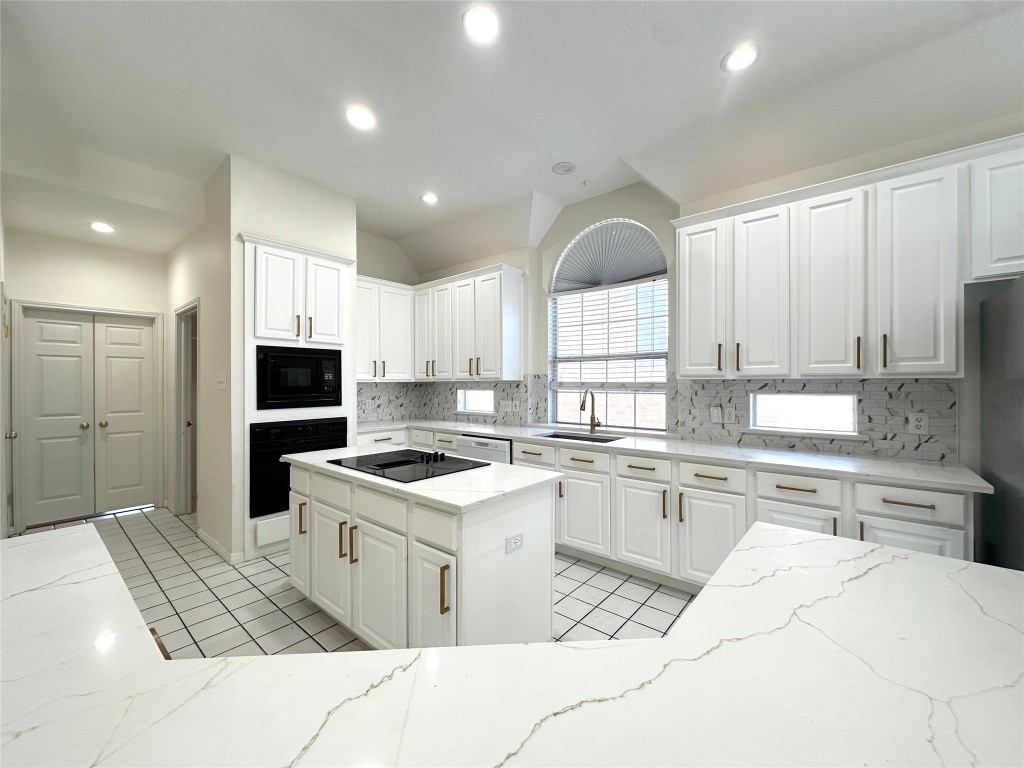 10305 Open Gate Drive Austin, TX 78726 - Photo 10 of 25 a kitchen with a sink a counter top space stainless steel appliances and cabinets