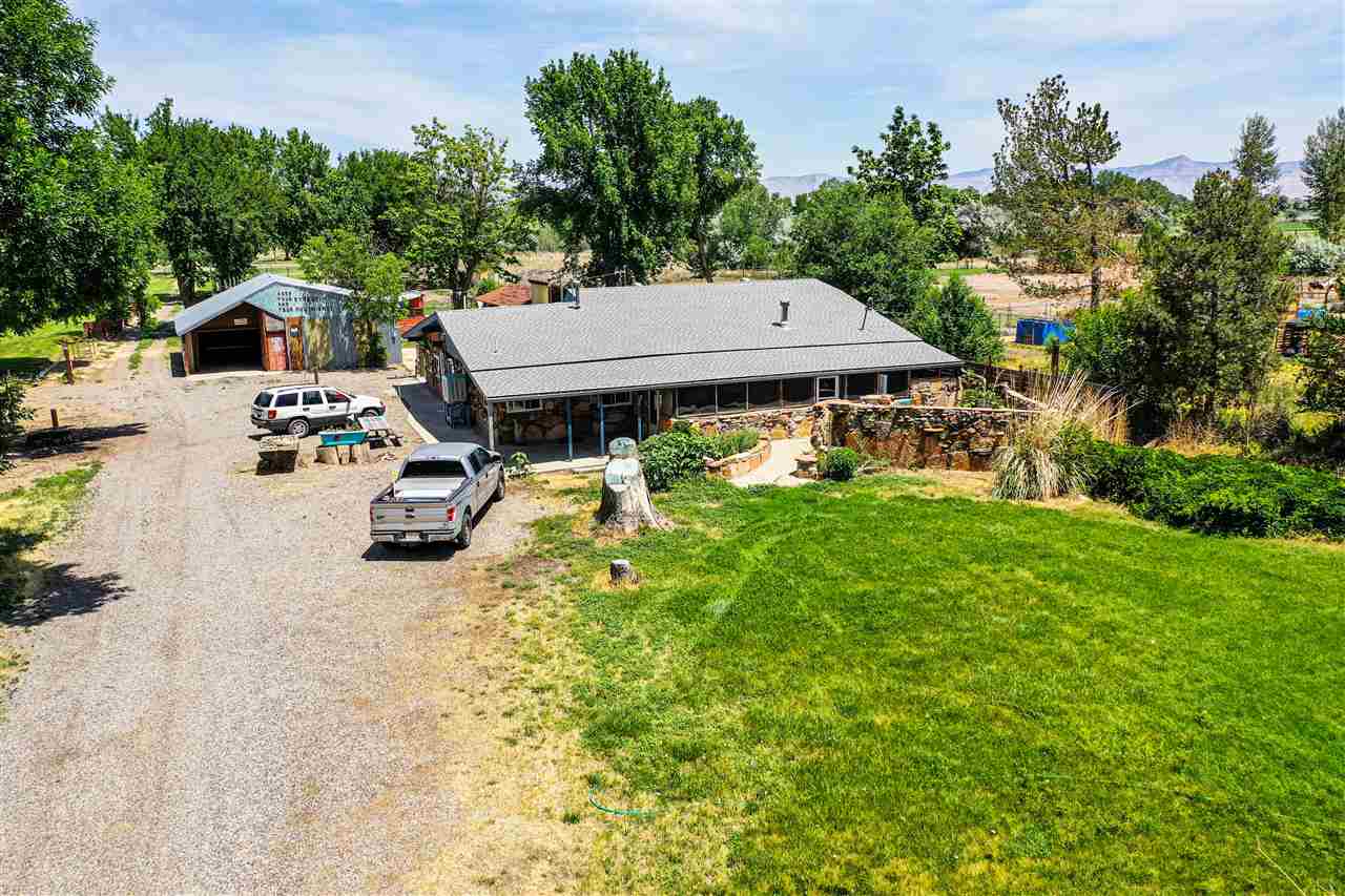 an aerial view of a house with swimming pool garden and patio