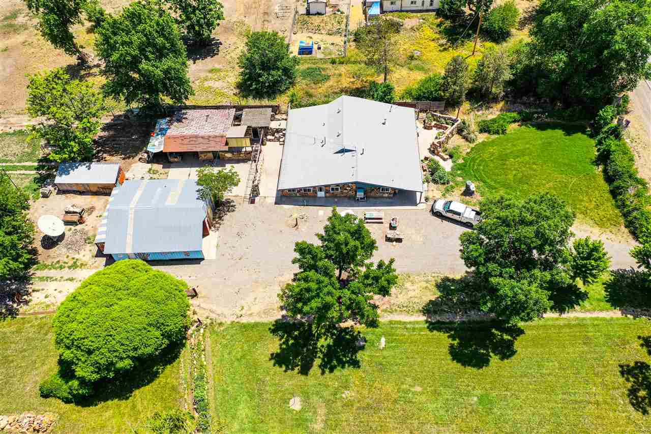 1862 J Road Fruita, CO 81521 - Photo 16 of 22 an aerial view of a house with a yard and lake view