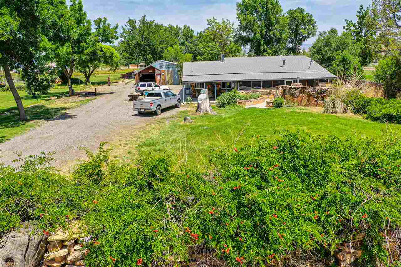 1862 J Road Fruita, CO 81521 - Photo 10 of 22 an aerial view of a house with garden space and trees