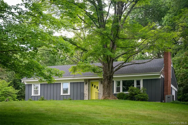 a front view of house with yard and green space