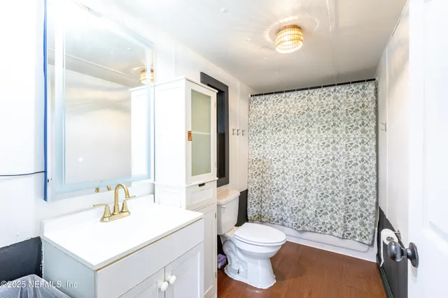 a bathroom with a sink toilet and shower